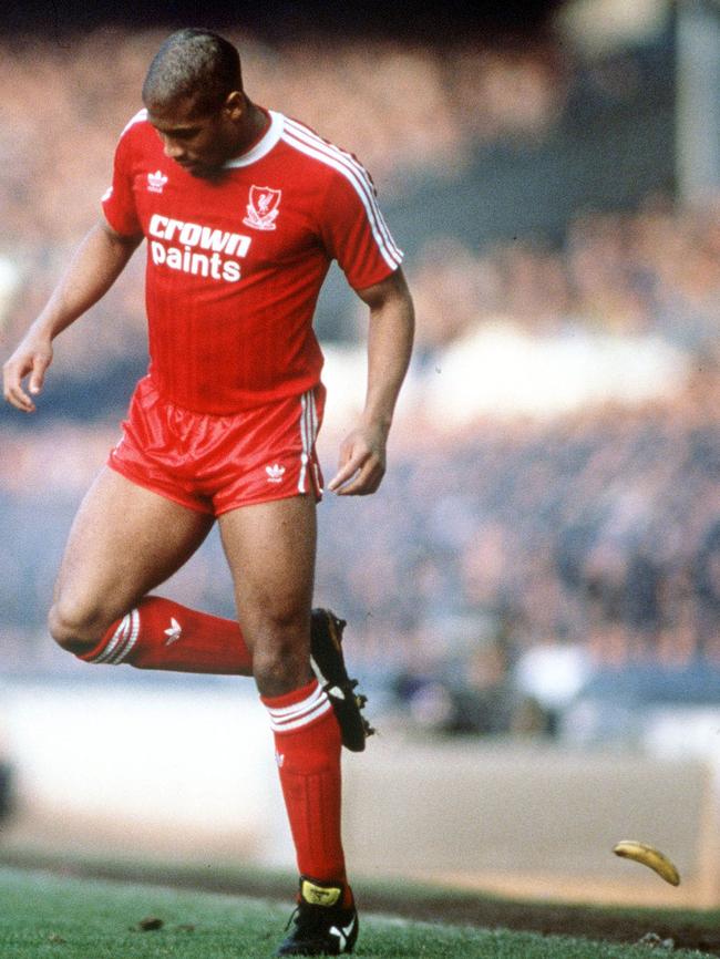 Liverpool's John Barnes backheels a banana that was thrown onto the pitch during a match against Everton. Photo: Bob Thomas/Getty Images