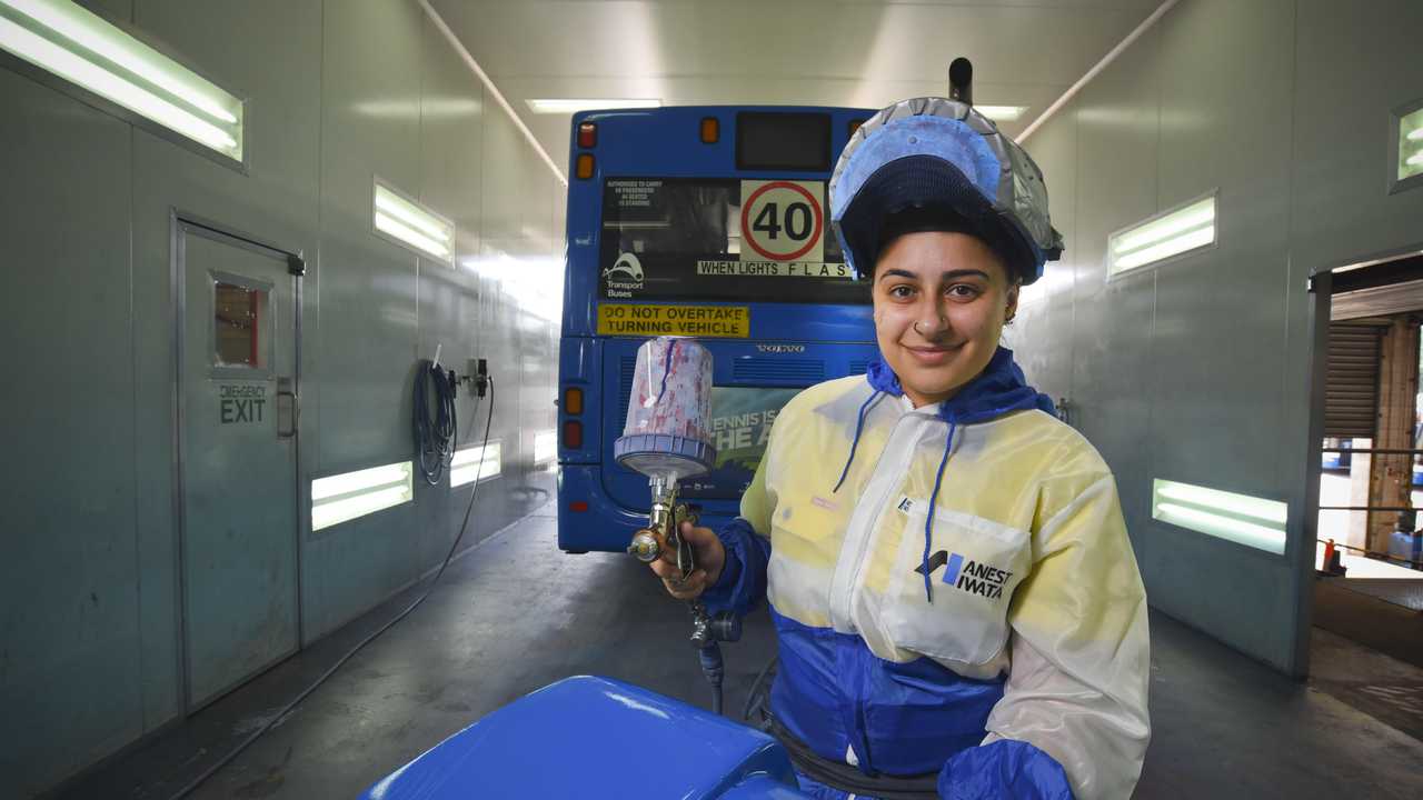 MOTORING ON: Apprentice bus painter Dimitria Klokas enjoys the challenge of difficult repairs. Picture: Dominic O'Brien