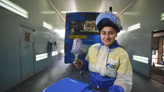 MOTORING ON: Apprentice bus painter Dimitria Klokas enjoys the challenge of difficult repairs. Picture: Dominic O'Brien