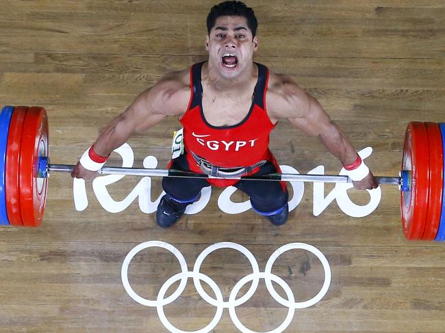 Egypt's Mohamed Mahmoud competes during the Men's 77kg weightlifting competition at the Rio 2016 Olympic Games in Rio de Janeiro on August 10, 2016. / AFP PHOTO / POOL / Stoyan Nenov