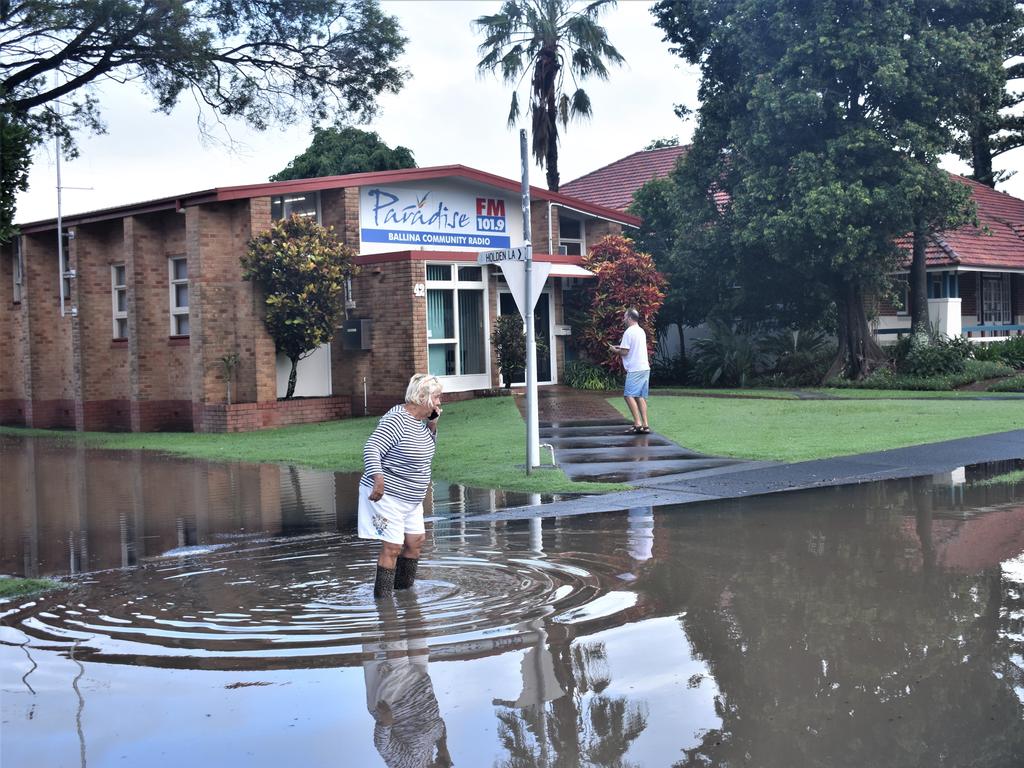 A Ballina resident wades in floodwater near the Ballina Shire Council chambers. Picture: Tessa Flemming