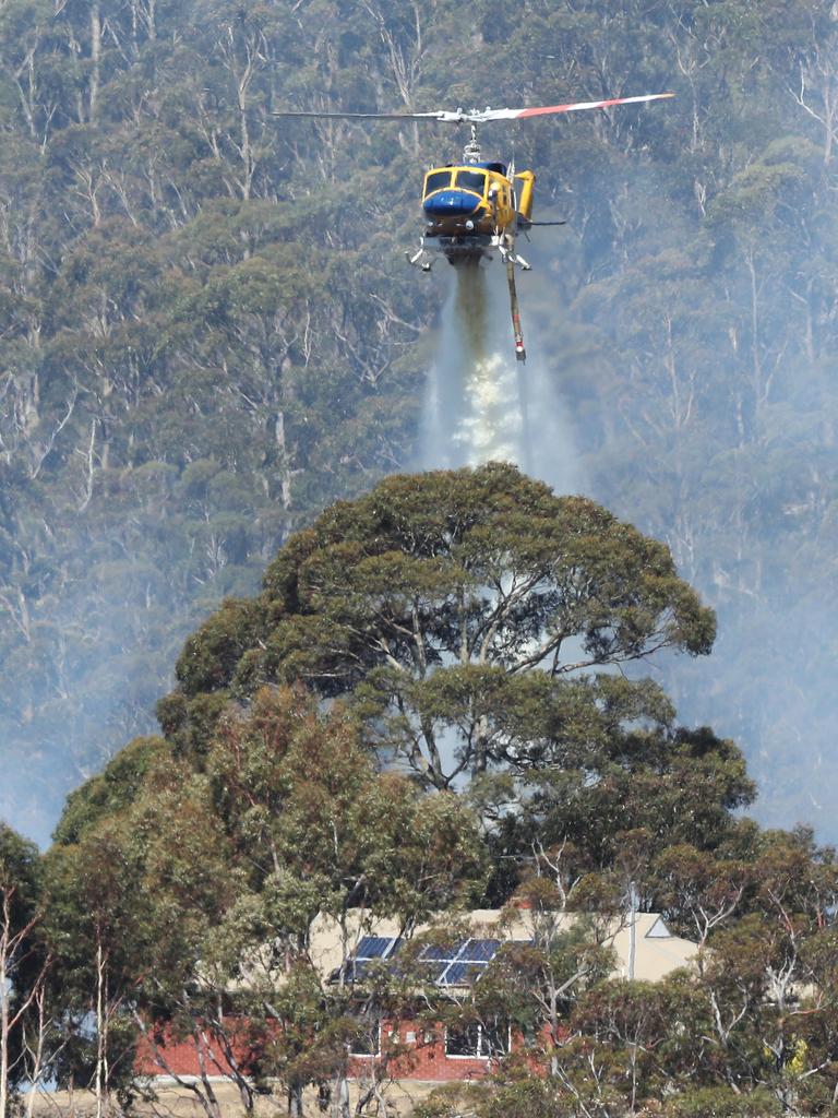 Helicopter dumps water on a home. Bushfire on Collinsvale Road Glenlusk. Picture: NIKKI DAVIS-JONES