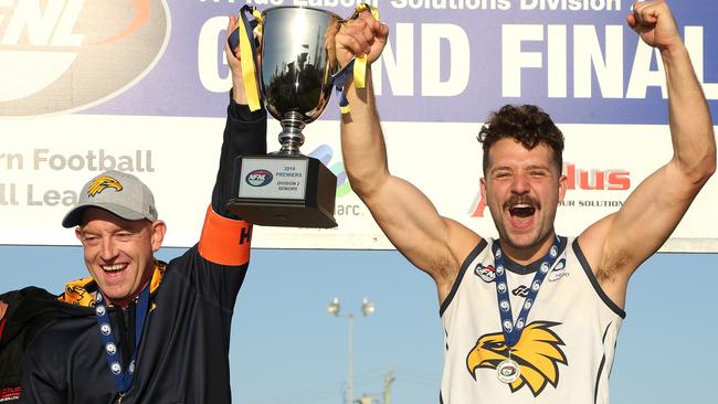 Whittlesea coach Blair Harvey and captain Riley Dyson lift the premiership trophy. Picture: Hamish Blair