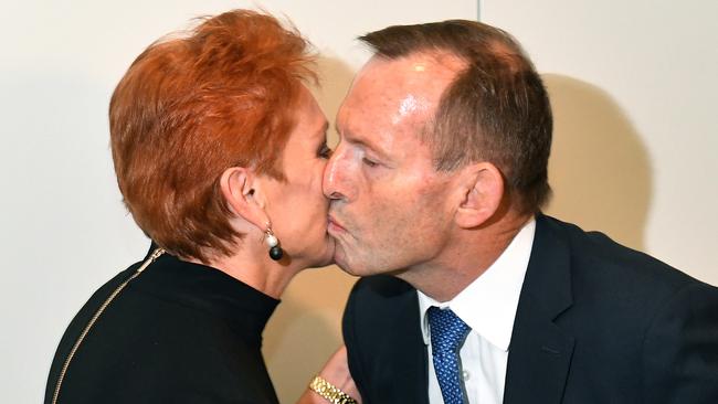 Pauline Hanson and Tony Abbott exchange pleasantries at Parliament House yesterday. Picture: AAP