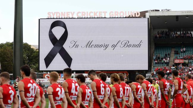 Sydney Swans players line up for a moments silence paying respect to the victims of the Bondi Junction tragedy. (Photo by Phil Hillyard)