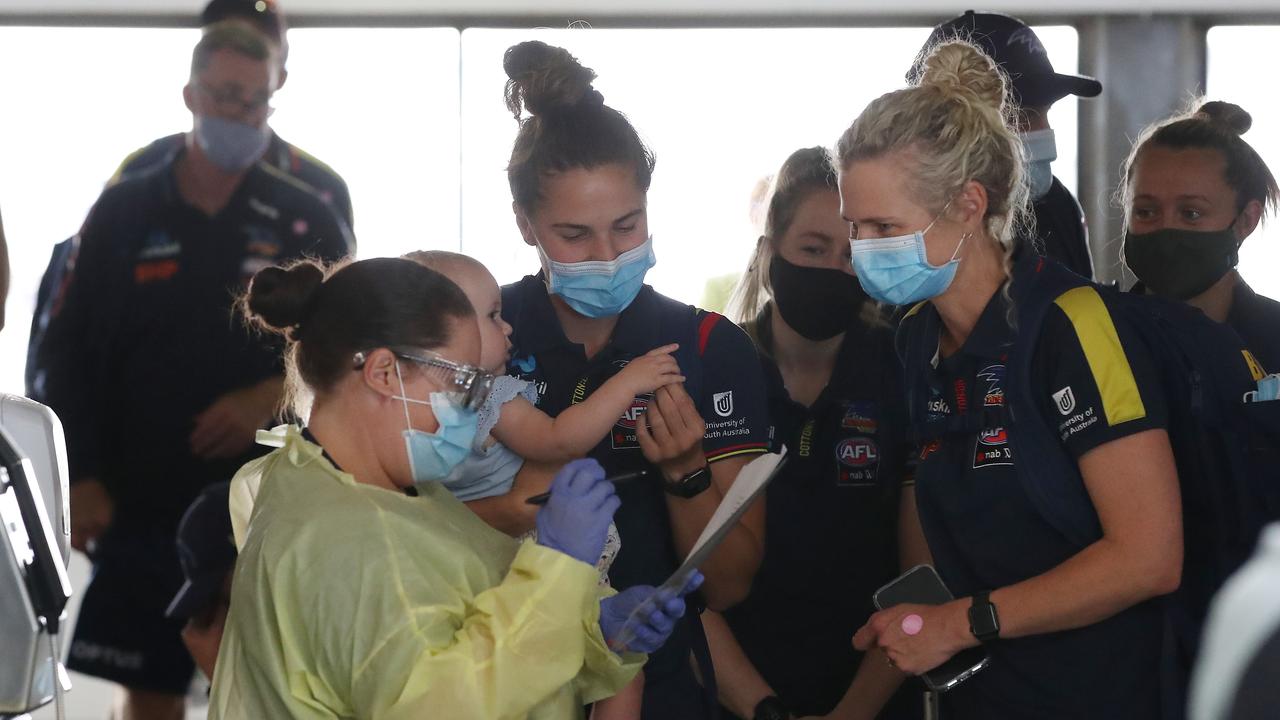 SYDNEY, AUSTRALIA - NewsWire Photos February 04 2021: The Adelaide Crows AFLW team arrived in Sydney this afternoon and were met by nurses and police as Sydney airport begins temperature testing incoming passengers. Picture: NCA NewsWire / David Swift