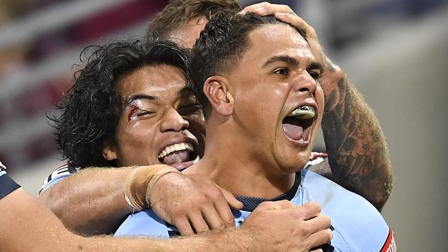 Latrell Mitchell celebrates with teammates after scoring a try during game one of the State of Origin series. Picture: Getty Images