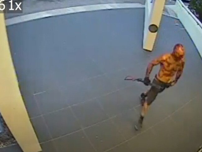 Ben Hoffmann armed with a shotgun and covered in blood outside NT Police's Peter McAulay Centre during his murderous rampage in June 2019.