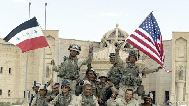 Flag-waving at the al-Faruq Palace in Tikrit, April 14, 2003. Picture: AFP. Getty Images/The Times