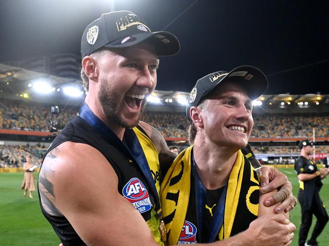 BRISBANE, AUSTRALIA - OCTOBER 24: Nathan Broad and Liam Baker celebrate victory after the 2020 AFL Grand Final match between the Richmond Tigers and the Geelong Cats at The Gabba on October 24, 2020 in Brisbane, Australia. (Photo by Bradley Kanaris/AFL Photos/via Getty Images)