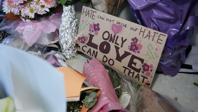 A sign among tributes to the Christchurch shooting victims. Picture: AAP / Emma Brasier 