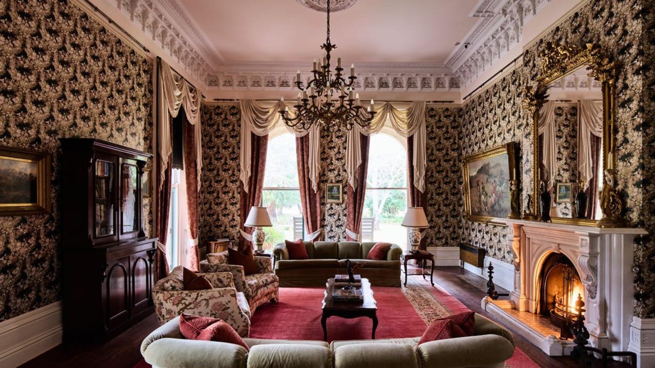 A living room with grand fireplace.