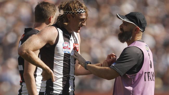 MELBOURNE, AUSTRALIA - SEPTEMBER 30: Nathan Murphy of the Magpies leaves the field with trainers during the 2023 AFL Grand Final match between Collingwood Magpies and Brisbane Lions at Melbourne Cricket Ground, on September 30, 2023, in Melbourne, Australia. (Photo by Daniel Pockett/AFL Photos/via Getty Images)