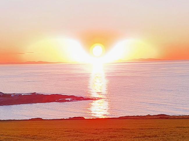 EXCLUSIVE: An amateur photographer tried to snap his dream sunset Ã¢â¬â and captured an angel. Stuart Murray, 56, whipped out his smartphone when he observed the sun going down from near his home in Portsoy, Scotland. The resulting pictures show it dipping and transforming into an angelic shape, complete with outstretched wings. Stuart explains: Ã¢â¬ÅI had been wanting to get a shot of the sun setting for years, but work or weather conditions usually got in the way. "However, the location I took the picture is only a ten minute walk from my house in the coastal town of Portsoy, where I have lived my whole life. Ã¢â¬ÅIt's a photograph of the sun going down over Northern Scotland, along the Moray Firth coast. I took it on the 1st June at 21.45. Ã¢â¬ÅMy thoughts on the Ã¢â¬ËAngelÃ¢â¬â¢: well, I'm not religious but I think I know what would spring to most people's minds if they saw the picture. Ã¢â¬ÅIf that gives one or two people a bit of comfort, so be it. I was only really looking for the classic picture of a sun setting. Ã¢â¬ÅAs for the effect the sun is giving off, I think, in my very limited use of my camera on my smartphone, it had something to do with the very clear and quiet still conditions that night. Ã¢â¬ÅI remember whilst taking the photo a tourist couple walked by and I said to them that I wasn't much of a photographer and that's still true.Ã¢â¬Â. 13 Jun 2022 Pictured: (CROP) The main 'angel' picture of the Sun setting. An amateur photographer tried to snap his dream sunset Ã¢â¬â and captured an angel. Stuart Murray, 56, whipped out his smartphone when he observed the sun going down from near his home in Portsoy, Scotland. The resulting pictures show it dipping and transforming into an angelic shape, complete with outstretched wings. Ã¢â¬ÅMy thoughts on the Ã¢â¬ËAngelÃ¢â¬â¢: well, I'm not religious but I think I know what would spring to most people's minds if they saw the picture. If that gives one or two people a bit of comfort, so be it.". Photo credit: Stuart Murray / SWNS / MEGA TheMegaAgency.com +1 888 505 6342 (Mega Agency TagID: MEGA868279_005.jpg) [Photo via Mega Agency]  Picture: Stuart Murray/SWNS/Mega