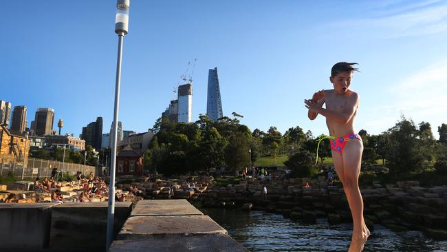A young swimmer jumps into the water at Marrinawi Cove on January 12, 2023 in Sydney, Australia. Swimmers can now enjoy a newly opened swimming area at Marrinawi Cove, located in Sydney's Barangaroo development, after a safety inspection was completed. Photo by Lisa Maree Williams/Getty Images)