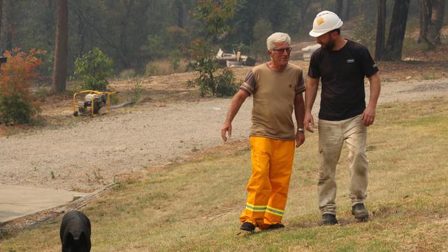 James Martin and Dave Davey prepare their properties for the approaching Gospers Mountain Fires.