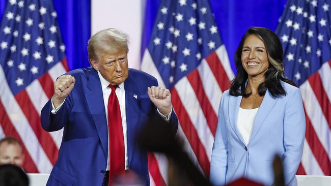 Donald Trump with his choice for intelligence chief in August. Picture: Kamil Krzaczynski/AFP/Getty Images