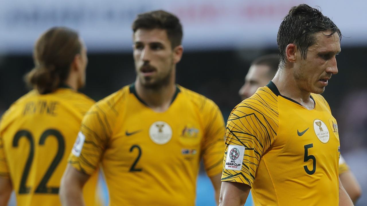 Australia's midfielder Mark Milligan, right, leaves the pitch with teammates at the end of the AFC Asian Cup group B soccer match between Australia and Jordan at Hazza bin Zayed stadium in Al Ain, United Arab Emirates, Sunday, Jan. 6, 2019. Jordan won 1-0. (AP Photo/Hassan Ammar)