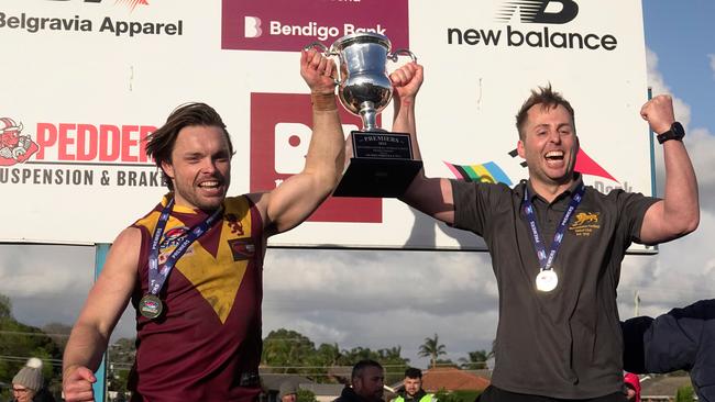 Captain Jordan Pollard (left) and coach Michael Kinsella raise the cup. Picture: Valeriu Campan