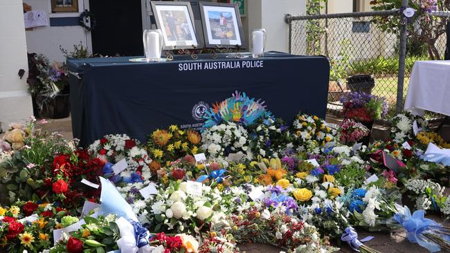 Floral tributes left by mourners who gathered to pay tribute to Brevet Sergeant Jason Doig. Picture: Riley Walter