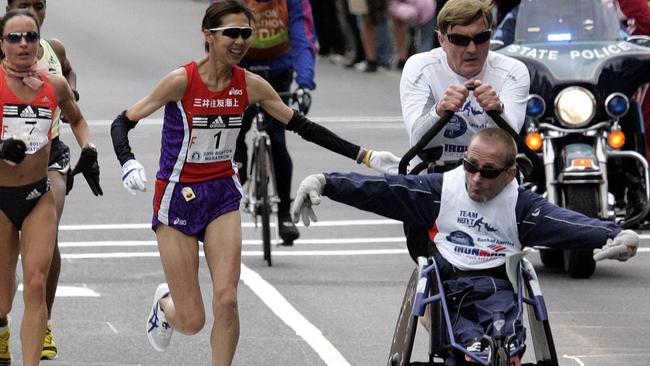 Dick Hoyt runs with his son Rick at their 25th Boston Marathon in 2006. Picture: AP Chitose Suzuki/AP.)