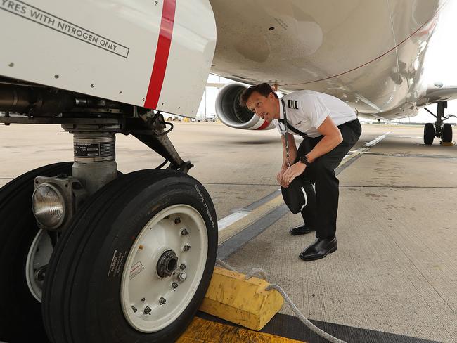 Virgin First Officer Ian Morrison performs a pre flight inspection on his aircraft. Virgin took almost $50m in JobKeeper payments. Lyndon Mechielsen/The Australian