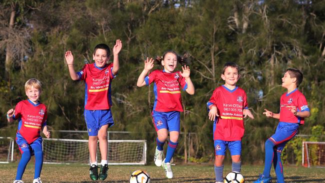 Junior football is back . Robina U/7 players from left,Joshua Clark, Yiannis Lekanis, Evie Woollett, Michael Barber and Kerry Cocoran-Mandiola celebrate.. Picture Glenn Hampson