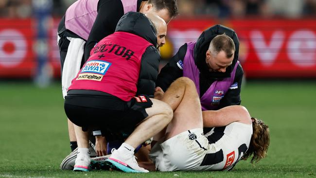 Nathan Murphy of the Magpies in the hands of medical staff. Picture: Dylan Burns/AFL Photos via Getty Images