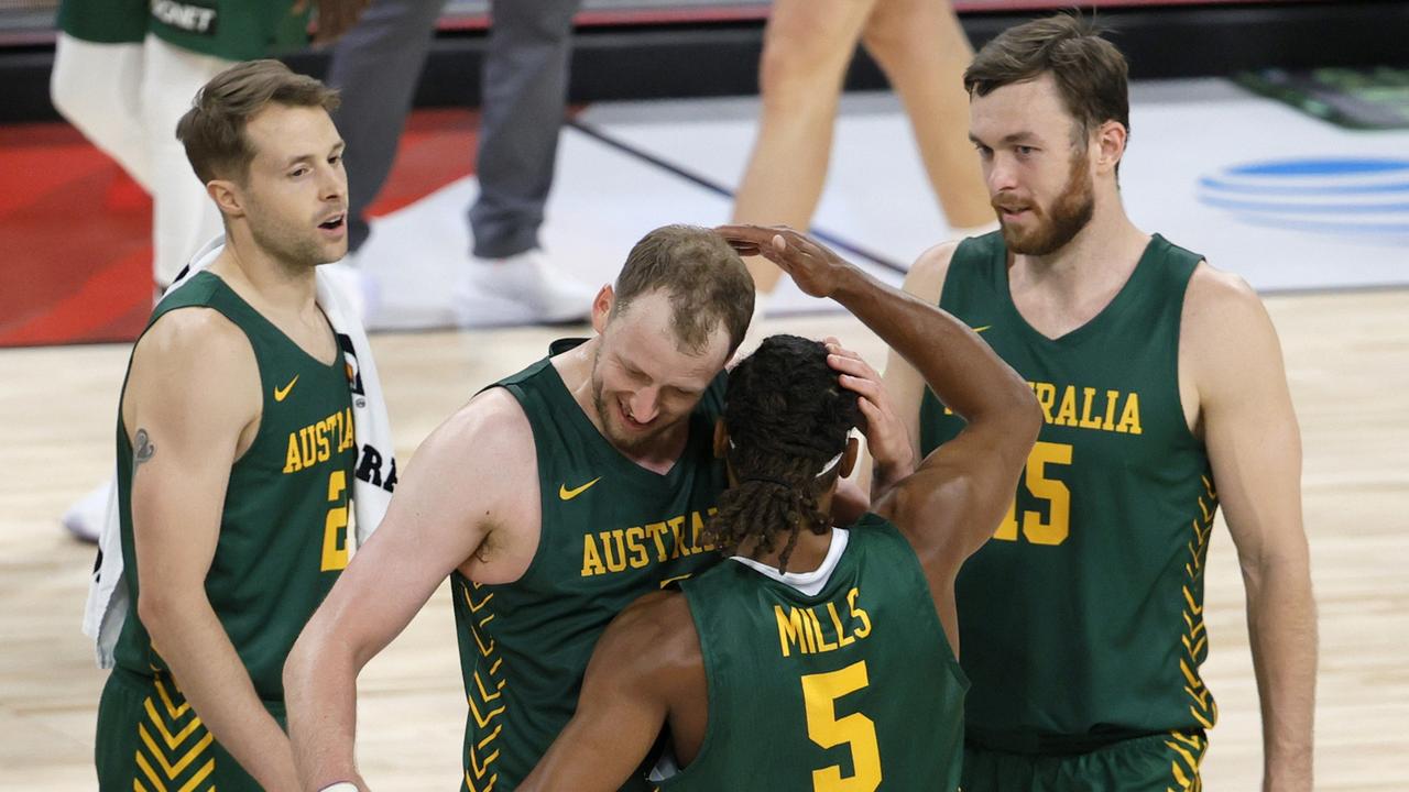 Patty Mills #5 of the Australia Boomers is congratulated by teammates Nathan Sobey #2, Joe Ingles #7 and Nick Kay #15 after Mills hit a 3-pointer against Argentina at the end of regulation of their exhibition game in 2021. (Photo by Ethan Miller/Getty Images)