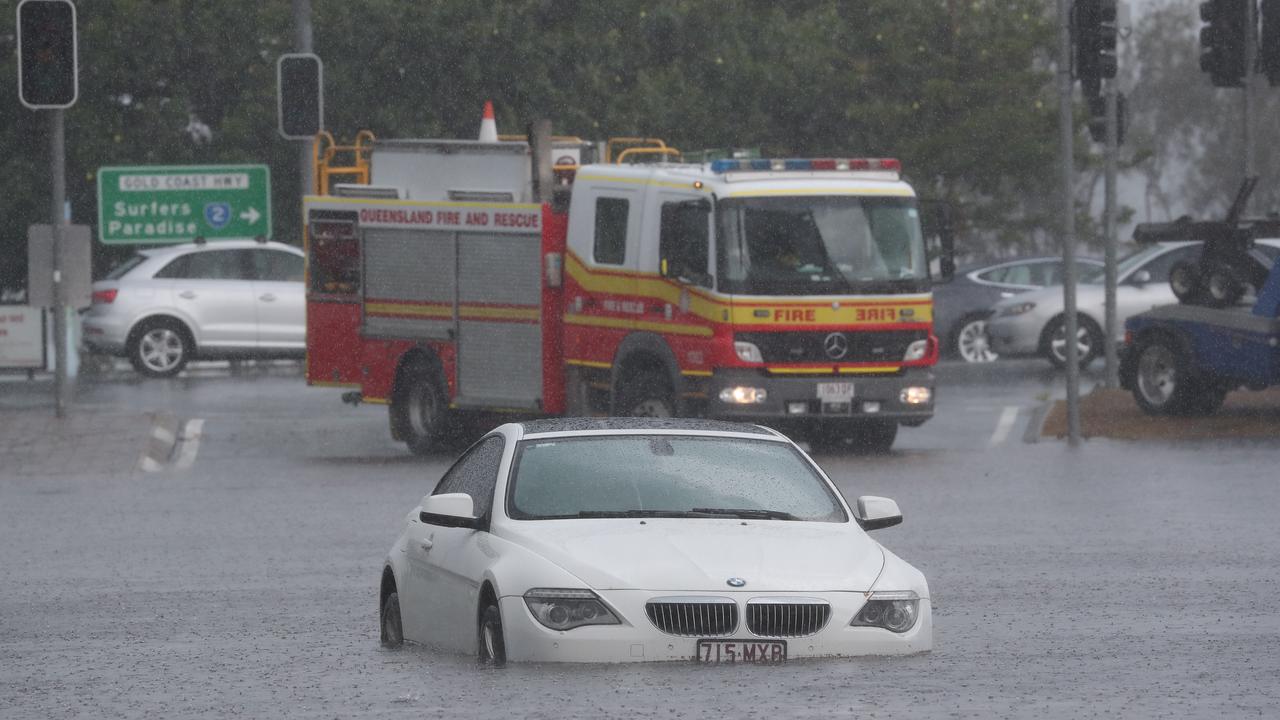 A car is flooded on Queen St in Southport after a storm lashes the Gold Coast. Picture: Jason O'Brien