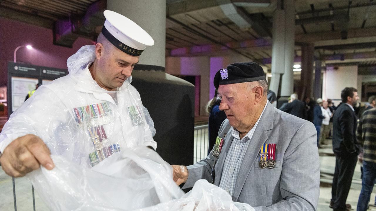 Ex-navy serviceman Daniel Sullivan and his father ex-Army serviceman Russell Sullivan prepare for a wet march to the Anzac Day Toowoomba Dawn Service, Tuesday, April 25, 2023. Picture: Kevin Farmer