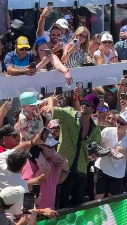 Young boy Beau does a shoey with DJ Fisher at LIV Golf