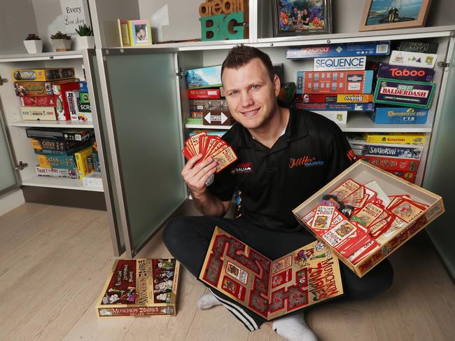 Jeff Horn with his cupboards of games. Picture: Annette Dew