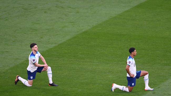 England players Declan Rice and Jude Bellingham of England take a knee prior to the FIFA World Cup Qatar 2022 Group B match between England and Iran. Picture: Getty Images