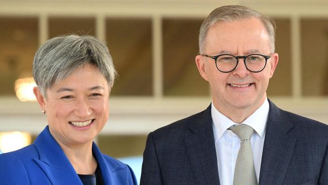 Australia's new Prime Minister Anthony Albanese (C) poses with his new cabinet ministers, Penny Wong (L) and Richard Marles after the oath taking ceremony at Government House in Canberra on May 23, 2022. (Photo by SAEED KHAN / AFP)