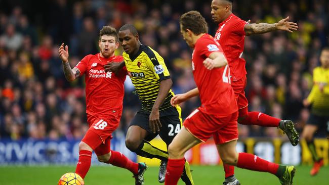 Watford striker Odion Ighalo proves too strong for three Liverpool players.