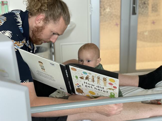 Nic van Essen and son George enjoy a story together. Picture: Supplied