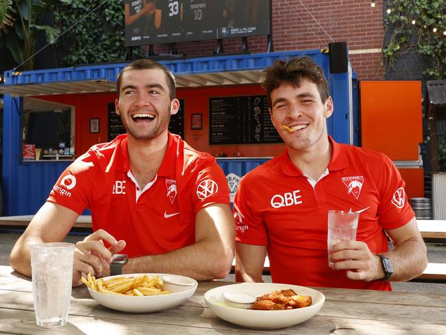 The Super bowl is now the biggest day on the calendar for many sports bars. Sydney Swans players Errol Gulden (left) and Logan McDonald enjoy a drink and chicken wings at The Alex in Alexandria. Picture: Jonathan Ng