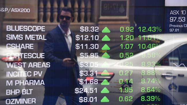 A pedestrian is reflected in the window of the Australian Securities Exchange. (AFP PHOTO/PETER PARKS)
