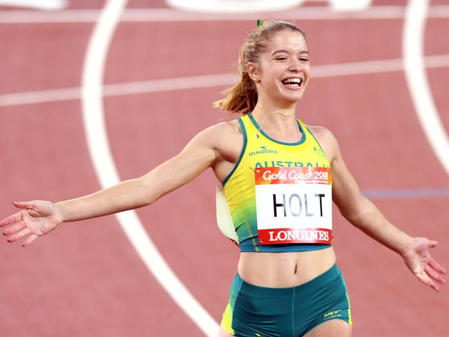 Isis Holt of Australia celebrates a gold medal win in the womens T35 100m on day seven of competition at Carrara Stadium on the Gold Coast, Australia, Wednesday, April 11, 2018. (AAP Image/Dean Lewins) NO ARCHIVING, EDITORIAL USE ONLY