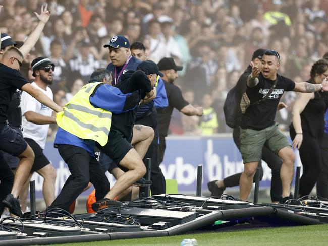 MELBOURNE, AUSTRALIA - DECEMBER 17: Fans storm the pitch in protest during the round eight A-League Men's match between Melbourne City and Melbourne Victory at AAMI Park, on December 17, 2022, in Melbourne, Australia. (Photo by Darrian Traynor/Getty Images)