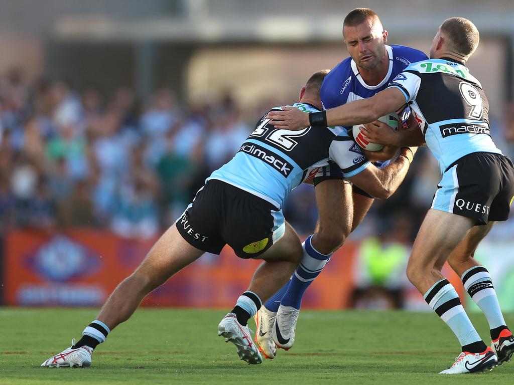 Jaeman Salmon of the Bulldogs is met by the defence. Photo: Mark Metcalfe/Getty Images