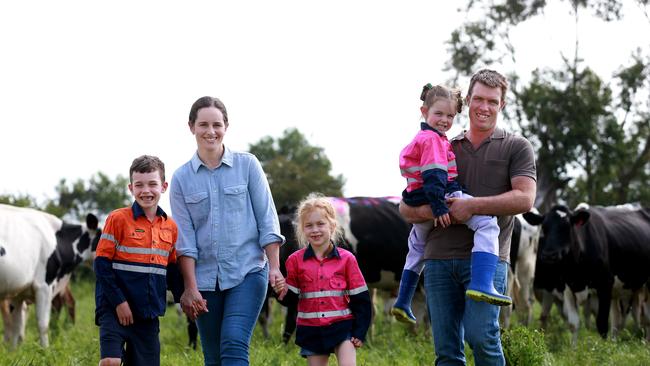 A walk in the park: Lauren and Simon Finger, with children Matthew, Claire and Rachael, on their farm in West Gippsland. The couple have simplified their dairy operation to ride out the tough times.