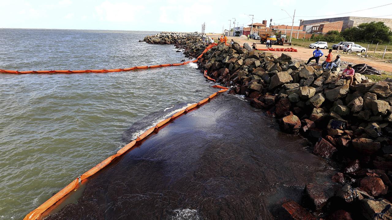 Some of the rocks stained by the oil spill in Aracaju, Brazil. Picture: Andre Moreira/Aracaju Municipal Press Office via AP.