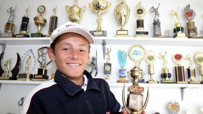 An 11-year-old Bernard Tomic with plenty of trophies. 