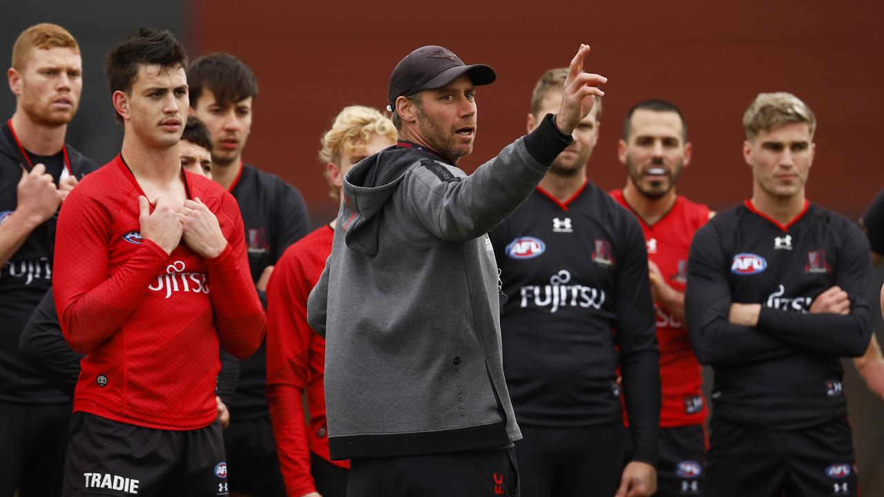 MELBOURNE, AUSTRALIA - AUGUST 18: Bombers head coach Ben Rutten (C) instructs his players during an Essendon Bombers AFL training session at The Hangar on August 18, 2022 in Melbourne, Australia. (Photo by Daniel Pockett/Getty Images)