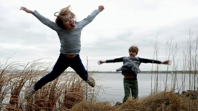 TAKE OFF: Pheobe and Miles play make-believe pelicans near the Murray Mouth and Coorong at Goolwa. Picture: Bernard Humphreys