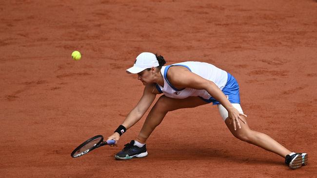 Australia's Ashleigh Barty returns the ball to Poland's Magda Linette during their women's singles second round tennis match on Day 5 of The Roland Garros 2021 French Open tennis tournament in Paris on June 3, 2021. (Photo by Anne-Christine POUJOULAT / AFP)