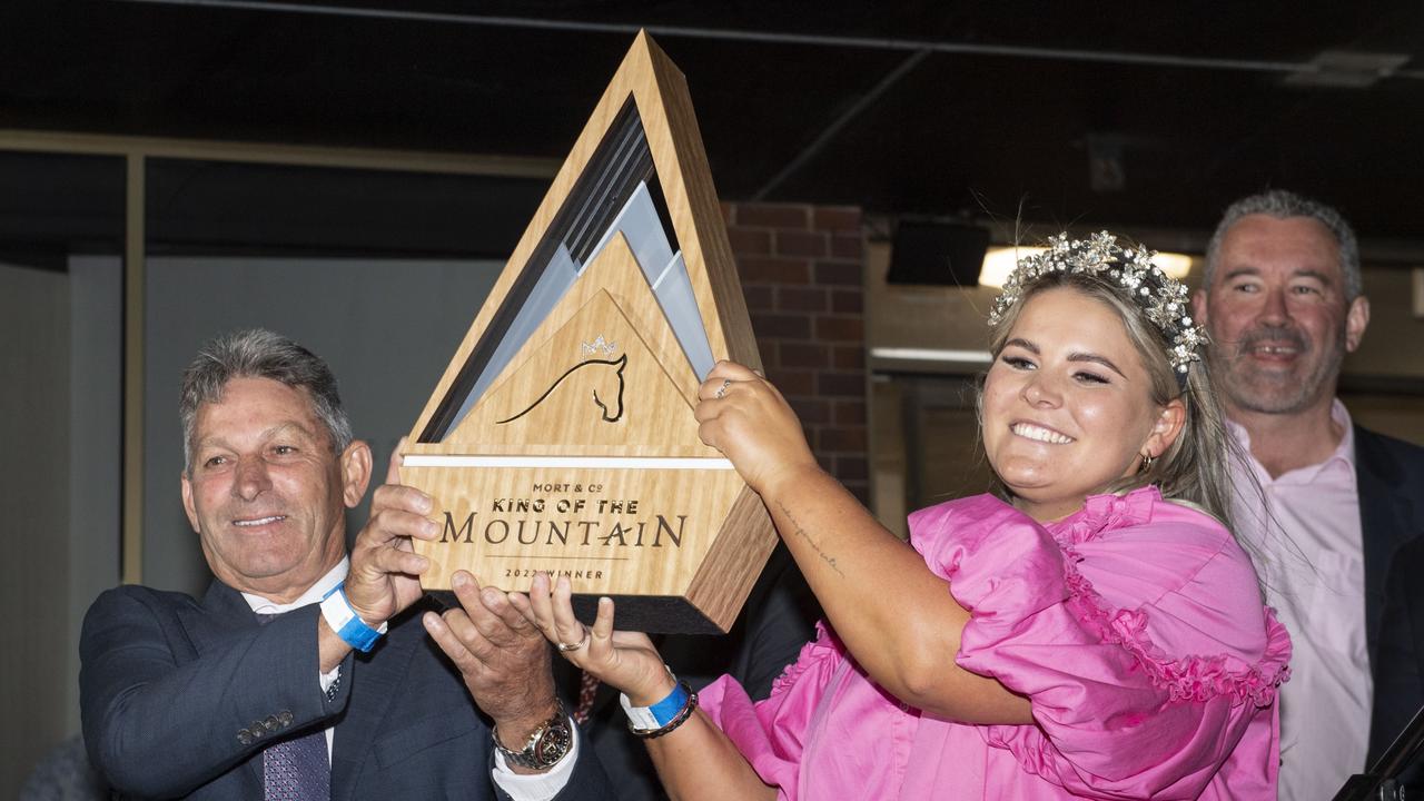 Tony and Maddy Sears hold the King of the Mountain trophy after Yellow Brick's win at Clifford Park racecourse.