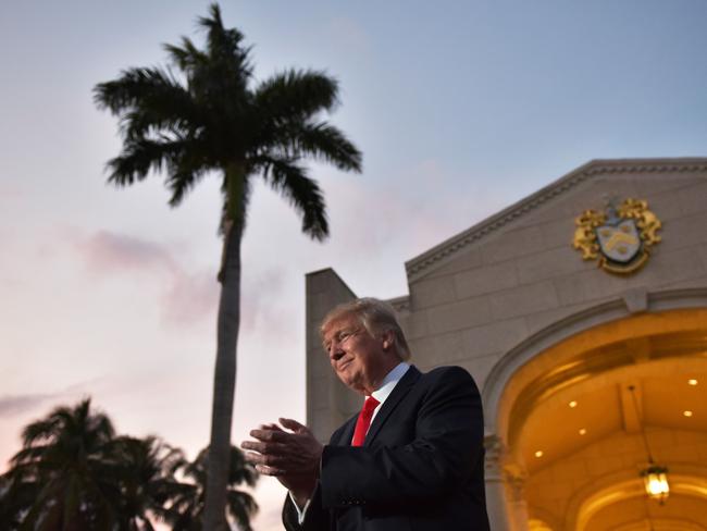 US President Donald Trump applauds as he is greeted by the Palm Beach Central High School marching band upon arrival to watch the Super Bowl at Trump International Golf Club Palm Beach. Picture: AFP